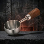 Silver stainless steel coffee scoop measuring 1 tablespoon with a long handle.